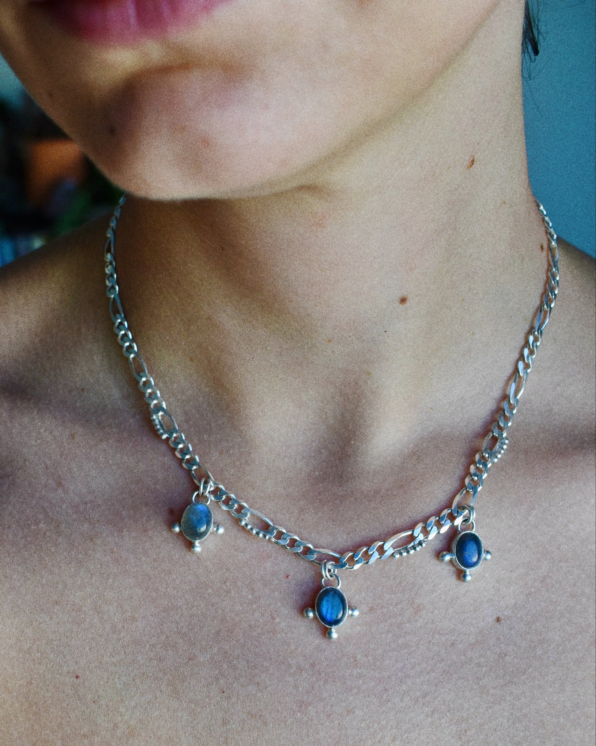 Silver Necklace with blue labradorite stones worn by a model